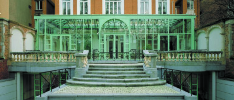 Old aluminium buildig facade in green.