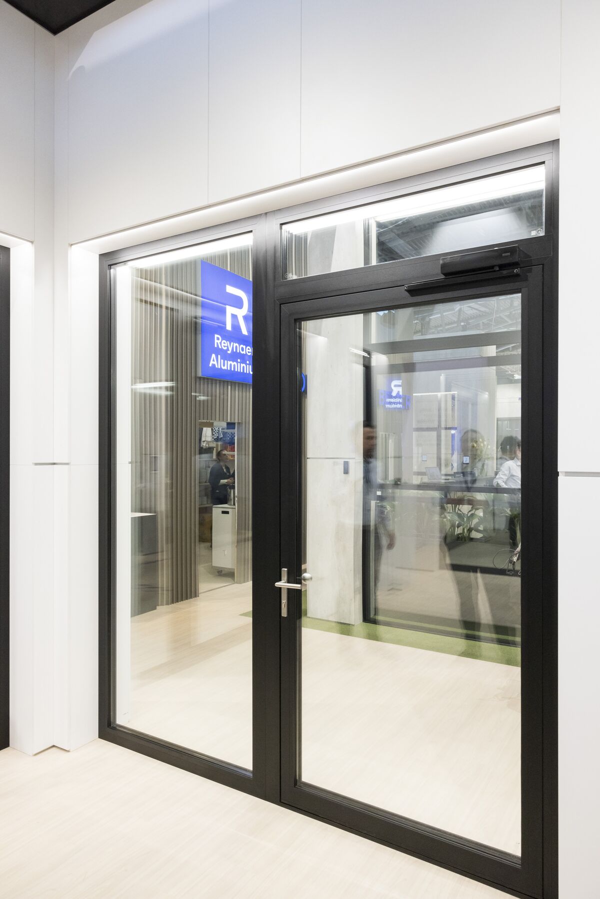 Black aluminium door at bright fair booth by Reynaers Aluminium.