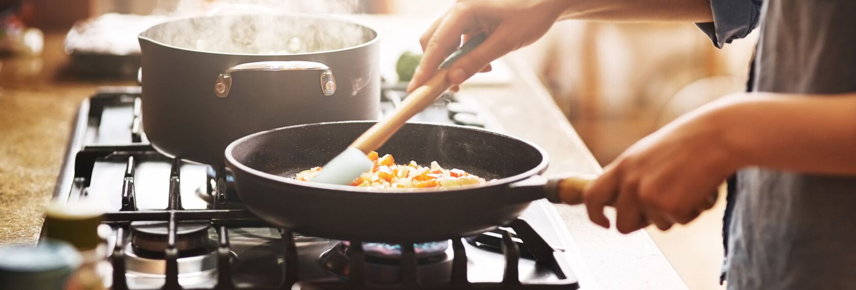 Cooking a meal on the stove, heat and moisture rising heavily.