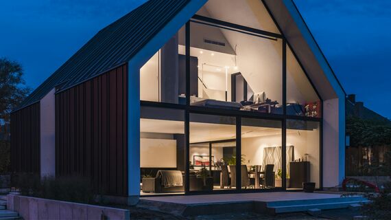 “Exterior nighttime view of private home in Bilzen, Belgium.